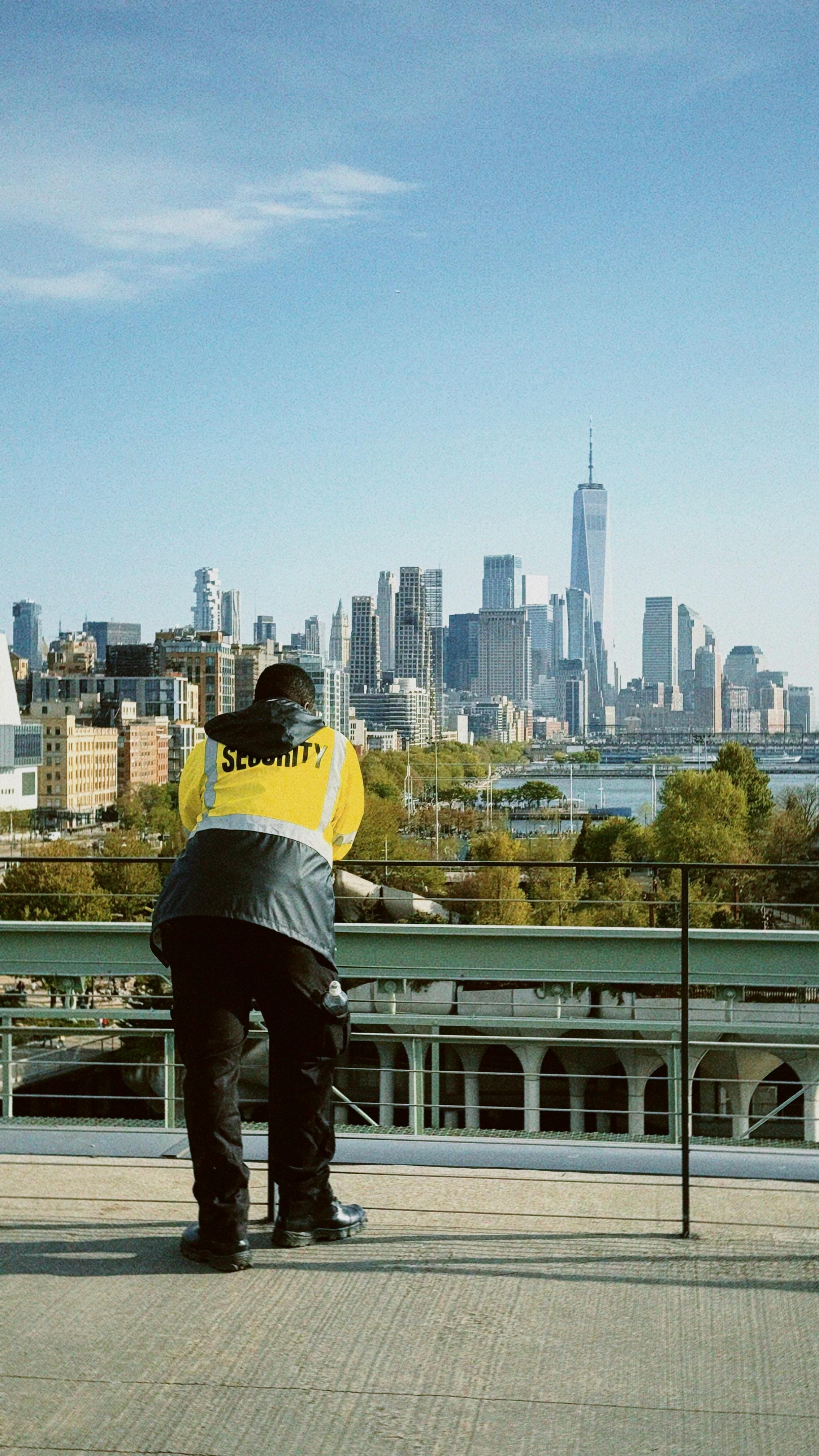 Professional security guard looking at city